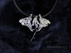 "Sterling silver Manta Ray with Shark pendant necklace Comes with one Black Neoprene Necklace: 16-18\" or 18-20\" or 20-22\" or a 17\" silver tone Ball Chain Manta Size: 2.75 cm x 3.21cm Pendant Weight: approx. 3.1grams Pendant Metal type: Solid 925 STERLING SILVER with Anti-Tarnish RHODIUM Finish Item Stamped \"925\" for Sterling Silver ** I designed and we created this item. Owned by Dive4Jewelry** Follow me on facebook for special announcements, Coupon codes and sales: www.facebook.com/Dive4J Shark Pendant, Shark Necklace, Shark Pattern, Fish Jewelry, Fish Necklace, Manta Ray, Cord Necklace, Ball Chain, Sterling Silver Pendant