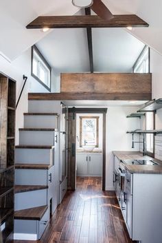 the interior of a tiny house with wood flooring