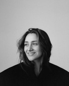 a black and white photo of a woman smiling