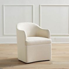 a white chair sitting on top of a hard wood floor