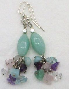 Add natural sparkle to any outfit with these creamy green amazonite cluster drop earrings! 2.5" in length, made with green amazonite beads/chips, purple amethyst, green fluorite, rose quartz, crystal quartz, blue aquamarine, and silver layered earhooks. These lovely amazonite cluster drop earrings ships to you in a gift box, ready to give as a present or to keep and store. Back To Beaded Earrings Green Amazonite, Green Fluorite, Natural Stone Jewelry, Chip Beads, Beaded Accessories, Rose Quartz Crystal, Aquamarine Blue, Crystal Quartz, A Present