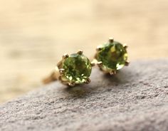 Solid 14k Gold stud earrings with brilliant cut vivid green and sparkly Peridot gemstones. Size of these Peridot gems is 5mm diameter and they have been set here in a 6 prong setting so that they get light also from underside. With 14k solid Gold ear nuts. Peridot is an August birthstone. These Peridot stud earrings come in a lovely Cantik! gift box and are ready to ship by registered airmail within 2 working days. Classic Green Peridot Earrings, Green Round Cut Earrings As Gift, Green Gemstone Earrings In 14k Gold, Green 14k Gold Birthstone Earrings, 14k Gold Green Birthstone Earrings, Green Gemstone Earrings, August Birthstone, Gemstone Stud Earrings, Gold Stud Earrings