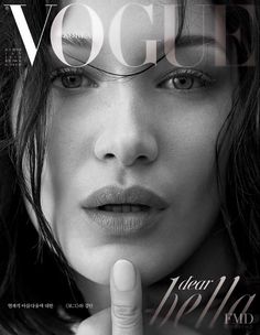 a woman with her finger on the cover of a magazine