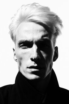 a black and white photo of a man with blonde hair