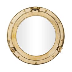 a round mirror with brass rivets on the front and sides, mounted to a wall