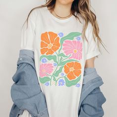 Hey there, fashionista! Looking to add a touch of elegance to your wardrobe? The "Floral Art Deco Collage" Graphic Tee is just what you need. Designed for those who appreciate the beauty of intricate patterns and timeless style, this tee brings a chic, artistic flair to your everyday look. Crafted from ultra-soft, high-quality fabric, this tee ensures maximum comfort and durability. The stunning floral art deco collage graphic is meticulously printed, offering a vibrant and eye-catching design t Art Deco Collage, Retro Floral Print T-shirt With Short Sleeves, Retro Pink Printed T-shirt, Bohemian Pink T-shirt With Graphic Print, Bohemian Pink Graphic Print T-shirt, Collage Graphic, Pink Bohemian Graphic T-shirt, Brunch Date, Hey There