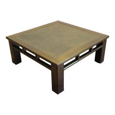 a square coffee table with an intricate design on the top