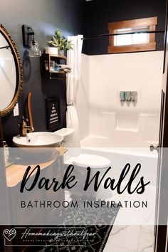 a bathroom with dark walls and white fixtures