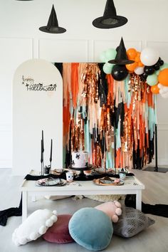 a table topped with lots of balloons and decorations