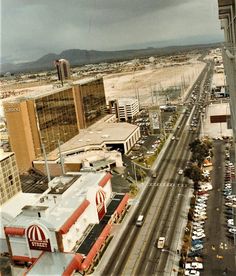 an aerial view of a city with cars and buildings