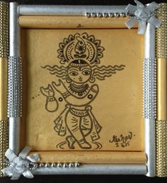 an intricately decorated gold and silver frame with a drawing of a person on it