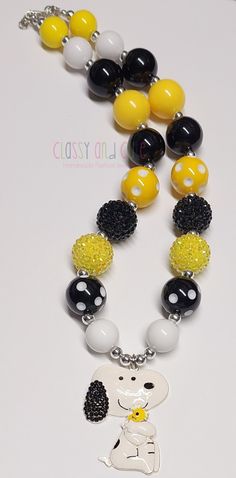 This listing is for one Snoopy bubblegum beaded necklace.  Use drop down box to chose your length. Available from 16 to 20 inches in length.  20mm black, yellow and white solid beads. 20mm black and yellow rhinestone beads.   20mm yellow polka dot beads and black polka dot beads.  6mm silver spacer beads. Metal enamel pendant is 2 inches in size. Necklace has a lobster clasp closure with a 2 inch extender chain. Product color may differ slightly due to photographic lighting sources or your monit Personalized Yellow Round Bead Jewelry, Playful Yellow Round Beads Jewelry, Cute Adjustable Yellow Necklaces, Cute Adjustable Yellow Necklace, Fun Black Jewelry For Birthday, Fun Yellow Jewelry For Birthday, Playful Black Round Bead Jewelry, Playful Black Beaded Jewelry, Fun Yellow Round Beads Jewelry