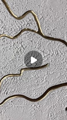 an abstract painting with gold and white paint