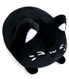 a black cat pillow with white eyes and paws on it's head, laying down