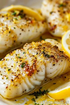 some fish with lemon slices and herbs on it