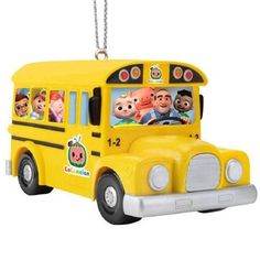 a yellow school bus ornament with cartoon characters on the front and back windows