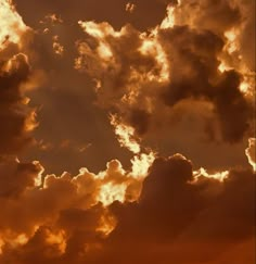 an airplane flying in the sky at sunset