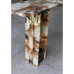 a marble table sitting on top of a cement floor