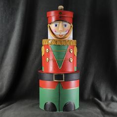 a wooden nutcracker is sitting on a black background