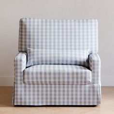 a blue and white checkered chair sitting on top of a hard wood floor