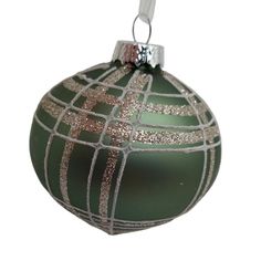 a green ornament with silver lines on it