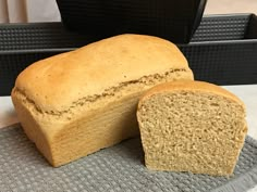 a loaf of bread sitting on top of a gray towel next to a black box