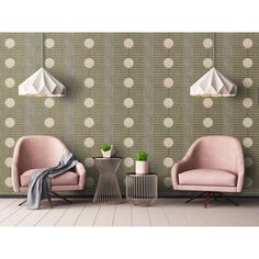 two pink chairs sitting next to each other in front of a polka dot wallpaper