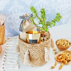 a basket filled with candles and nuts on top of a table next to other items