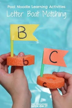 two hands holding up letters on sticks with water in the background and an orange stick that says letter boat matching