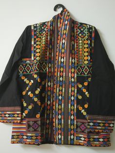 "Black Suzani partywear Long jacket Indian Cotton embroidery Coat Handmade Ladies embroidery dress Cotton kimono robe quilted Boho jacket  This stylish Embroidery Jacket crafted from a comfortable fabric, this eye-catching piece is perfect for any occasion. Its unique design features intricate details and embroidered patterns that are sure to make a statement. Easy to Carry, You Can Wear It on Your Party Attire, Daily Wear, You Can Use This as Beachwear, Lounge wear and as a Regular Outfit, This One Product Will Be Suitable for your Multiple Occasions. Wear it with any black and white dress, or with jeans to add color and beauty. Handmade in India. Size:-One size (plus) US women's letter Measurements: Length: 32\" Inches Bust : 44\" Inches Sleeve : 20\" Inches Color : Same As Picture Fabri Long Sleeve Patchwork Kimono For Festivals, Traditional Spring Kimono With Intricate Embroidery, Embroidered Multicolor Kimono For Winter, Winter Multicolor Embroidered Kimono, Embroidered Multicolor Winter Kimono, Folk Style Multicolor Embroidered Long Sleeve Kimono, Traditional Kimono With Multicolor Embroidery For Spring, Traditional Spring Kimono With Multicolor Embroidery, Folk Style Multicolor Embroidery Kimono With Long Sleeves