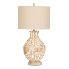 a table lamp with a white shade on it and a beige fabric lampshade