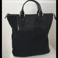 Calvin Klein Tote Black Fabric And Black Patent Leather Approximately 13 1/2” Tall. 14” Wide. 4 1/2” Wide Strap Drop Approximately 4” 4 Interior Slip Pockets 1 Interior Zippered Pocket Silver Hardware Used Twice Excellent Like New Condition Interior And Exterior Large Enough For An Overnight Bag Or Chic Laptop Tote Sophisticated And Rare Design Calvin Klein Tote Bag, Calvin Klien, Reversible Tote Bag, Calvin Klein Bags, Calvin Klein Bag, Calvin Klein Red, Laptop Tote, Black Leather Tote Bag, Monogram Tote