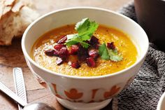 a white bowl filled with soup and garnished with cilantro