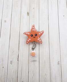 "Starfish Badge Reel  This little starfish is made with a beautiful coral color glitter. Glitter and details sealed with resin for a smooth long lasting finish and shine! Pearl accents are 3D! Measures approximately 2\" wide by 2\" tall. This is made to hold ID badges, choose from an alligator swivel clip, belt clip, MRI safe badge clip, or lanyard - see listing photos for examples of each! ⭐️ Alligator Swivel Clip ⭐️  Most popular option! The swivel spring clip on the back of the reel provides Clip Belt, Cute Badge Reel, Nurse Badge Holders, Id Badge Holders, Belt Clip, Badge Holder, Id Badge, Badge Holders Lanyard, Coral Color