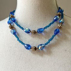 "Vintage Double Strand Faceted Royal Blue Crystal Glass Spacers Beaded Necklace One of the prettiest blue necklaces in my collection Faceted aurora borealis teardrop shape beads in 3 different sizes, separated by glass beads and accentuated with brass filigree beads with clear rhinestones in the middle Even a lock is truly exceptional! Longest strand drops down to approximately 18\", shorter strand is about 15\"-16\" Very good vintage condition with minor signs of wear and aging" Vintage Blue Double Strand Necklaces, Luxury Vintage Blue Beaded Necklace, Blue Multi-strand Gemstone Necklaces, Vintage Blue Glass Beaded Necklaces, Blue Multi-strand Necklace With Polished Beads, Double Ring, Blue Necklace, Multi Strand Necklace, Strand Necklace