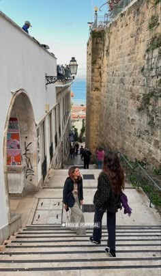 two people are walking up and down the stairs