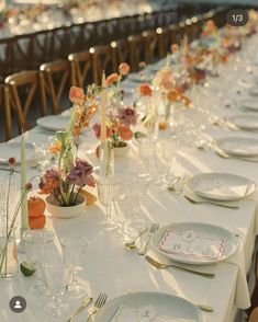 a long table is set with plates and silverware