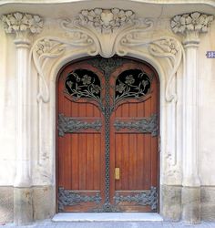 an ornate wooden door with iron work on it