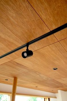 an overhead view of a living room with wood paneling and lighting fixtures on the ceiling