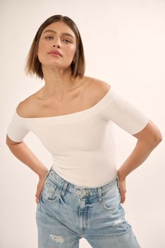 Ribbed knit bodysuit. Off-shoulder neckline with banded trim. Short sleeves. Full-coverage bottom with snap crotch. Fitted silhouette. Shaper Fit styles feature premium stretch fabric and contour fit designed to sculpt the body. 73% Viscose, 27% Nylon. Imported. Designed in LA. Model wears size S. All bodysuit sales are final. Summer Stretch Knit Top With Ribbed Neckline, White Fitted Off-shoulder Knit Top, Casual Off-shoulder Stretch Bodysuit, Spring White Off-shoulder Bodysuit, Seamless Off-shoulder Top For Summer, Seamless Off-shoulder Summer Top, Fitted Ribbed Off-shoulder Knit Top, Fitted Off-shoulder Ribbed Knit Top, Stretch Off-shoulder Trendy Bodysuit