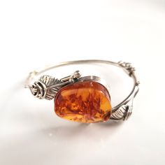 Classic freeform amber cuff bracelet in silver Handmade Adjustable Baltic Amber Jewelry, Amber Bracelet With Polished Finish As Gift, Amber Polished Bracelet For Gift, Amber Bracelets With Polished Finish For Gifts, Elegant Amber Bangle Bracelet, Amber Bracelets With Polished Finish As A Gift, Adjustable Amber Jewelry With Polished Finish, Amber Bangle Jewelry For Gift, Adjustable Amber Bracelet For Formal Occasions