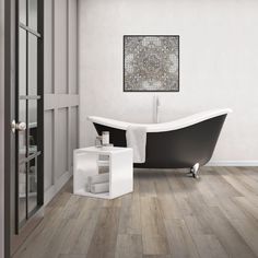 a bath tub sitting next to a wooden floor