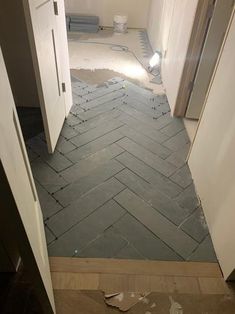 an empty room that is being remodeled with tile on the floor and in between two doors