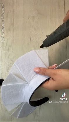 someone is cutting paper with scissors on a table