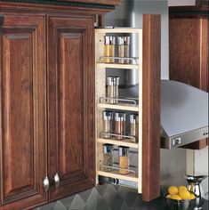 an open cabinet in a kitchen filled with spices