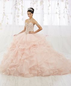 Command attention in this long strapless sweetheart tulle dress with layered skirt by House of Wu 26911 during your Quinceanera, Sweet 16 party, or for any formal event. This fun princess ball gown features a fully beaded strapless bodice accented with corset boning for shape and structure. Cascades of dramatic tulle and horsehair add a touch of drama to the floor length ruffled skirt. This look is finished with a corset back and a beautiful train. House of Wu Quinceanera Collection Spring 2019 Dream Quinceanera, Meadow Sweet, Quinceanera Collection, Quinceañera Ideas, Sweet 16 Party, Military Ball Dresses, Champagne Dress, Quinceanera Dress, Princess Ball Gowns