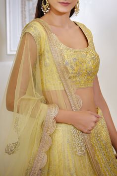 Yellow kalidar lehenga embroidered with zari dori work. Comes with matching blouse and sheer embellished dupatta.
Components: 3
Fabric: Silk and viscose
Neckline: Round
Sleeve Length: Cap
Color: Yellow
Embroidery
Scalloped hem lehenga
Dupatta with scalloped border and tassels
Back tie up with tassels
Closure:
Blouse: Hook back - Aza Fashions Light Yellow Fabric, Blouse Yoke, Light Yellow Color, Lehenga Dupatta, Embroidered Lehenga, Yellow Silk, Casual Tunics, Silk Lehenga, Indian Ethnic Wear