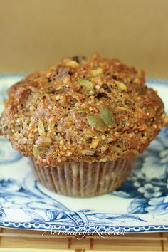 a muffin sitting on top of a blue and white plate