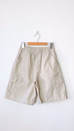 Vintage Women's Ivory/Stone Beige Elastic Shorts/Cargo Shorts. Measurements Length          : 20" Waist             : 24-32" Hips               : 38" Inseam          :  8 1/2" Rise               :  12" Condition     :  I don't think it's worn. Good condition.  ※Please read the policy before you purchase※ Utility Style Short Cargo Pants In Beige, Beige Short Utility Cargo Pants, Beige Utility Cargo Shorts With Cargo Pockets, Beige Utility Cargo Style Shorts, Beige Short Cargo Pants With Cargo Pockets, Beige Outdoor Bottoms With Multiple Pockets, Beige Utility Shorts With Cargo Pockets, Beige Cargo Style Bottoms For Outdoor, Beige Utility Cargo Pants Short Length