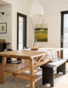 a dining room with a bench and table in it